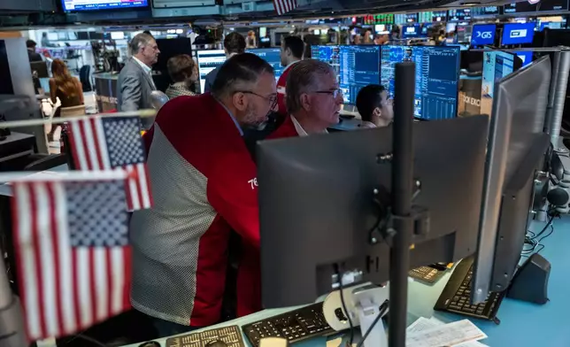 Traders Daniel Kryger, right, and Aman Patel, left, work on the floor of the New York Stock Exchange, Friday, Aug. 7, 2026, in New York. (AP Photo/Yuki Iwamura)