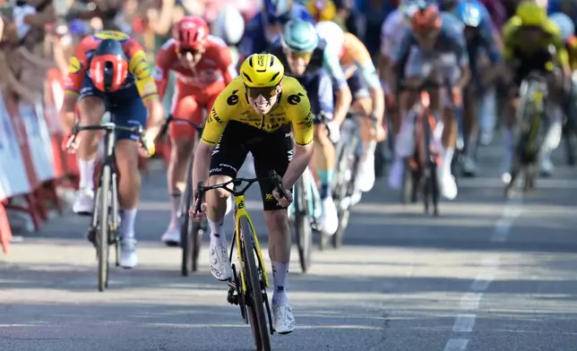 Britain's Matthew Brennan sprints to win the second stage of the La Vuelta cycling race, with start in Monaco and finish in Manosque, France, Sunday, Aug. 23, 2026. (AP Photo/Philippe Magoni)