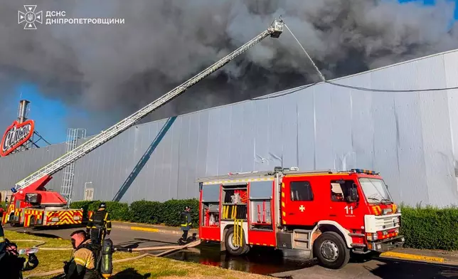 In this photo provided by the Ukrainian Emergency Service, firefighters work on a fire at a shopping mall following a Russian drone attack in Kryvyi Rih, Ukraine, Friday, Aug. 21, 2026. (Ukrainian Emergency Service via AP)