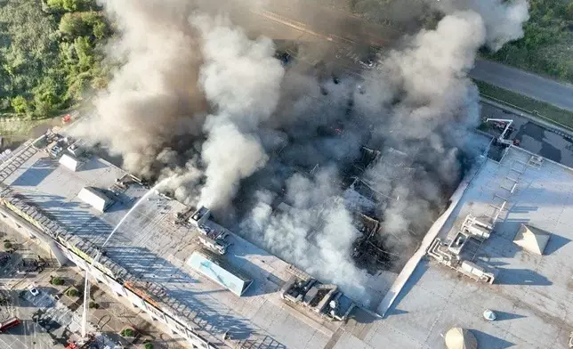In this photo provided by the Ukrainian Military administration, firefighters work on a fire at a shopping mall following a Russian drone attack in Kryvyi Rih, Ukraine, Friday, Aug. 21, 2026. (Ukrainian Military administration via AP)