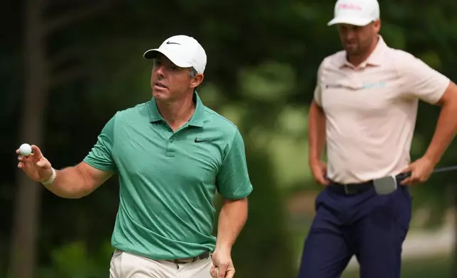 Rory McIlroy, of Northern Ireland, walks off the nineth green as Wyndham Clark is seen in the final round of the BMW Championship golf tournament, Sunday, Aug. 23, 2026, in St. Louis. (AP Photo/Jeff Roberson)