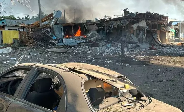In this photo, provided by the Ukrainian Emergency Service, fire is seen on the site of a Russian air attack in Pechenihy, Kharkiv region, Ukraine, Tuesday, Aug. 18, 2026. (Ukrainian Emergency Service via AP)