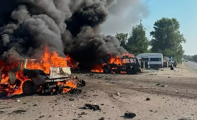 In this photo provided by the Ukrainian Emergency Service, fire is seen on the site of a Russian air attack in Pechenihy, Kharkiv region, Ukraine, Tuesday, Aug. 18, 2026. (Ukrainian Emergency Service via AP)