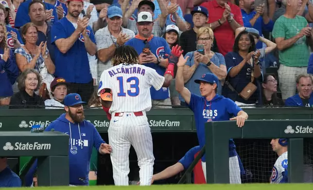 Chicago Cubs' Kevin Alcantara (13) is greeted at the dugout after hitting a two-run home run against the Los Angeles Dodgers during the second inning of a baseball game Monday, Aug. 3, 2026, in Chicago. (AP Photo/David Banks)