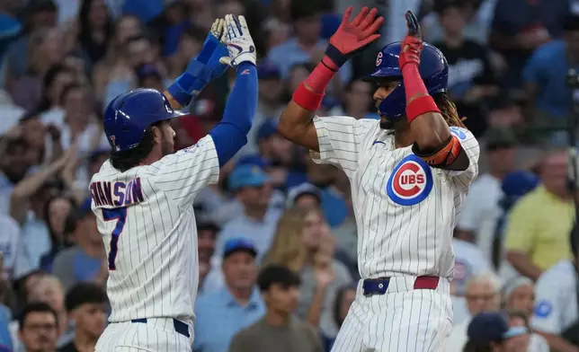 Chicago Cubs' Kevin Alcantara, right, is greeted by Dansby Swanson after hitting a two-run home run against the Los Angeles Dodgers during the second inning of a baseball game, Monday, Aug. 3, 2026, in Chicago. (AP Photo/David Banks)