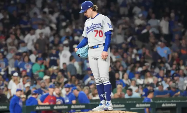 Los Angeles Dodgers pitcher Justin Wrobleski looks down as he is about to leave a baseball game against the Chicago Cubs during the fifth inning Monday, Aug. 3, 2026, in Chicago. (AP Photo/David Banks)