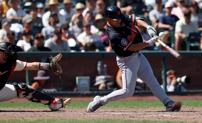 Detroit Tigers' Hao-Yu Lee, right, hits an RBI single in front of San Francisco Giants catcher Drew Cavanaugh, left, during the 10th inning of a baseball game in San Francisco, Sunday, Aug. 9, 2026. (AP Photo/Jed Jacobsohn)