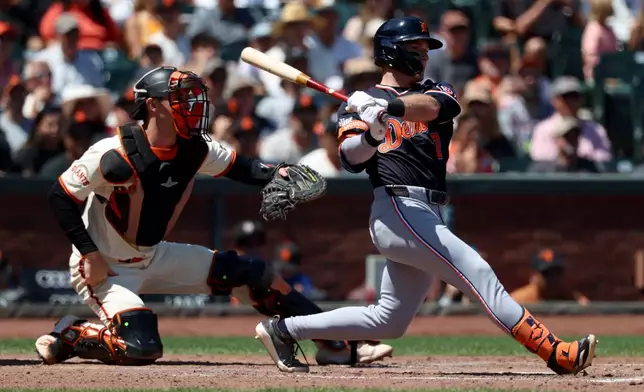 Detroit Tigers' Kevin McGonigle (7) watches his single in front of San Francisco Giants catcher Daniel Susac, left, during the sixth inning of a baseball game in San Francisco, Sunday, Aug. 9, 2026. (AP Photo/Jed Jacobsohn)