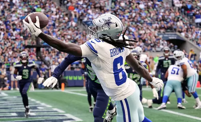Dallas Cowboys wide receiver Camden Brown (6) catches a touchdown pass in front of Seattle Seahawks cornerback Michael Dansby, rear, in the second half of an NFL preseason football game, Saturday, Aug. 15, 2026, in Seattle. (AP Photo/Stephen Brashear)