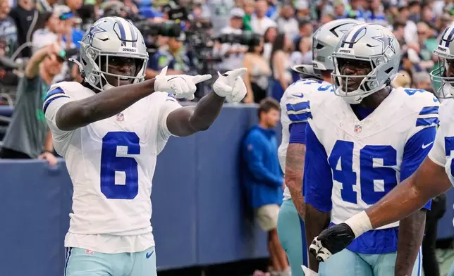 Dallas Cowboys wide receiver Camden Brown (6), Michael Trigg (46) and others celebrate Brown's touchdown catch in the second half of an NFL preseason football game against the Seattle Seahawks, Saturday, Aug. 15, 2026, in Seattle. (AP Photo/Stephen Brashear)