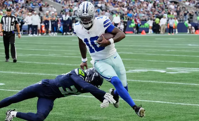 Dallas Cowboys quarterback Joe Milton III (10) runs the ball as Seattle Seahawks cornerback Michael Dansby (37) attempts to make the stop in the second half of an NFL preseason football game, Saturday, Aug. 15, 2026, in Seattle. (AP Photo/Stephen Brashear)