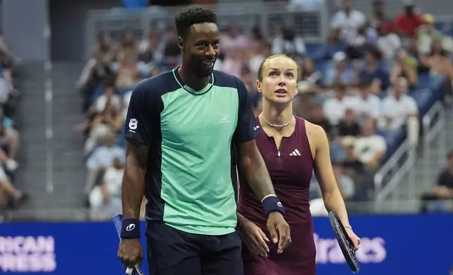 Elina Svitolina, of Ukraine, and Gael Monfils, left, of France, react while competing against Belinda Bencic, of Switzerland, and Flavio Cobolli, of Italy, during a mixed doubles semifinal match at the U.S. Open tennis championships Wednesday, Aug. 26, 2026, in New York. (AP Photo/Frank Franklin II)