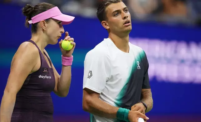 Belinda Bencic, left, of Switzerland, and Flavio Cobolli, of Italy, react while competing against Elina Svitolina, of Ukraine, and Gael Monfils, of France, during a mixed doubles semifinal match at the U.S. Open tennis championships Wednesday, Aug. 26, 2026, in New York. (AP Photo/Frank Franklin II)