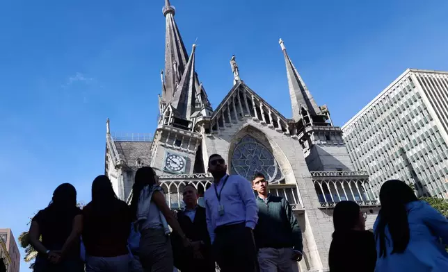 Residents stand outside the Cathedral of Manizales after it was damaged by an earthquake in Manizales, Colombia, Monday, Aug. 10, 2026.(AP Photo/John Jairo Bonilla)