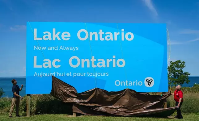 Ontario Premier Doug Ford, right, and Niagara West Member of Provincial Parliament Sam Oosterhoff unveil a sign for Lake Ontario at the Fifty Point Conservation Area in Grimsby, Ontario, Canada, on Saturday, Aug. 29, 2026. (Keito Newman/The Canadian Press via AP)