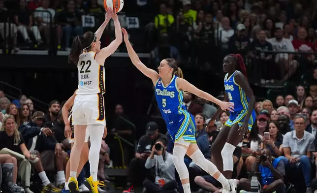 Indiana Fever guard Caitlin Clark (22) goes up to shoot against Dallas Wings guard Paige Bueckers (5) during the first half of a WNBA basketball game in Dallas, Thursday, Aug. 20, 2026. (AP Photo/LM Otero)