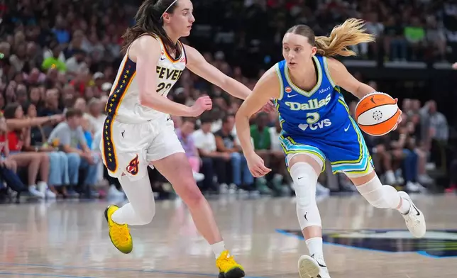 Dallas Wings guard Paige Bueckers, right, drives against Indiana Fever guard Caitlin Clark, left, during the first half of a WNBA basketball game in Dallas, Thursday, Aug. 20, 2026. (AP Photo/LM Otero)