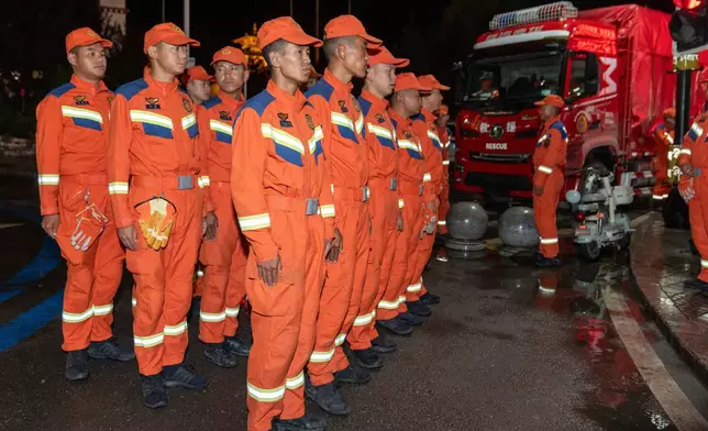 In this photo released by Xinhua News Agency, rescuers prepare before heading to the mudslide-stricken area near Gyirong Port in Gyirong County, southwestern China's Tibet Autonomous Region early Thursday, Aug. 27, 2026. (Tenzing Nima Qadhup/Xinhua via AP)