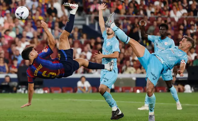 Barcelona's Pau Cubarsi, left, and Athletic Bilbao's Aymeric Laporte challenge for the ball during a Spanish La Liga soccer match between Barcelona and Athletic in Barcelona, Spain, Thursday, Aug. 27, 2026. (AP Photo/Joan Monfort)