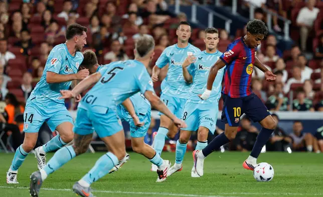 Barcelona's Lamine Yamal controls the ball surrounded by Athletic players during a Spanish La Liga soccer match between Barcelona and Athletic in Barcelona, Spain, Thursday, Aug. 27, 2026. (AP Photo/Joan Monfort)