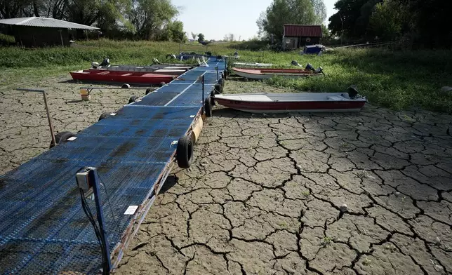 Boats sit on dry ground as water levels have dropped on the Danube River in Petrovaradin, Serbia, Tuesday, Aug. 25, 2026. (AP Photo/Darko Vojinovic)