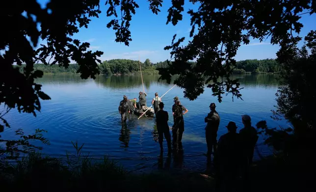 Fishermen prepare for a fish haul of the Kanov pond near the town of Trebon, Czech Republic, Wednesday, Aug. 26, 2026. (AP Photo/Petr David Josek)
