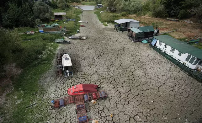 Boats sit on dry ground as water levels have dropped on the Danube River in Petrovaradin, Serbia, Tuesday, Aug. 25, 2026. (AP Photo/Darko Vojinovic)