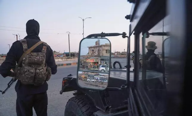 Soldiers formerly with the Kurdish-led Syrian Democratic Forces stand guard in Hasakah, northeastern Syria, Wednesday, Aug. 26, 2026. The force announced its dissolution Tuesday after completing its merger with the Syrian army. (AP Photo/Baderkhan Ahmad) ADDITION: Adds that the SDF announced its dissolution Tuesday after completing its merger with the Syrian army.