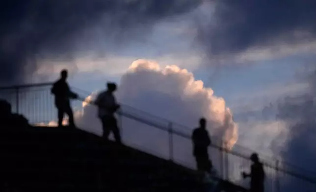 Fans walk down the stands during the fourth inning of a baseball game between the Philadelphia Phillies and the Washington Nationals Wednesday, Aug. 5, 2026, in Philadelphia. (AP Photo/Matt Slocum)