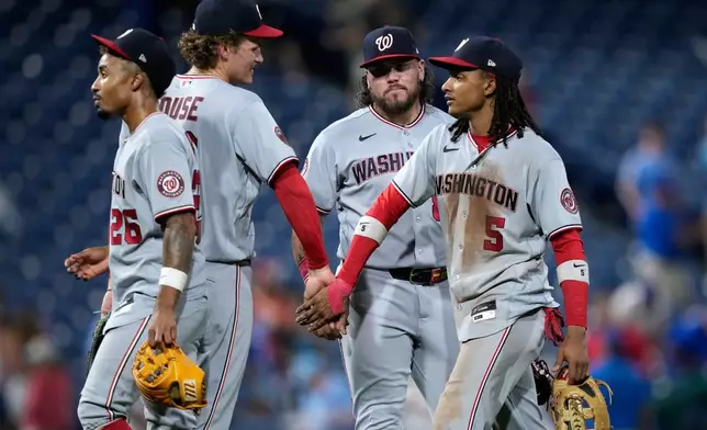 Washington Nationals' Nasim Nuñez, from left, Brady House, Andrés Chaparro and CJ Abrams celebrate after the Nationals won a baseball game against the Philadelphia Phillies in 1 innings Wednesday, Aug. 5, 2026, in Philadelphia. (AP Photo/Matt Slocum)