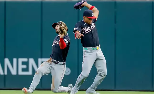 Washington Nationals second baseman José Tena, right, catches fly ball hit by Atlanta Braves catcher Joey Bart, as Nationals right fielder Dylan Crews avoids a collision during the second inning of a baseball game, Friday, July 31, 2026, in Atlanta. (AP Photo/Erik S. Lesser)