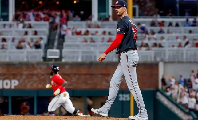 Washington Nationals pitcher Foster Griffin, right, reacts on the mound after giving up a three-run home run to Atlanta Braves' Michael Harris II, left, during the sixth inning of a baseball game, Friday, July 31, 2026, in Atlanta. (AP Photo/Erik S. Lesser)