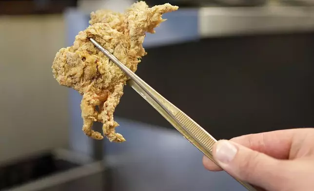 A breaded green crab is pulled from a fryer at Signal restaurant Tuesday, June 16, 2026, in Kennebunk, Maine. (AP Photo/Robert F. Bukaty)