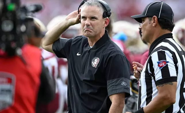 FILE - Florida State head coach Mike Norvell, center, reacts during the first half of an NCAA college football game against Alabama, Saturday, Aug. 30, 2025, in Tallahassee, Fla. (AP Photo/Phelan M. Ebenhack, File)
