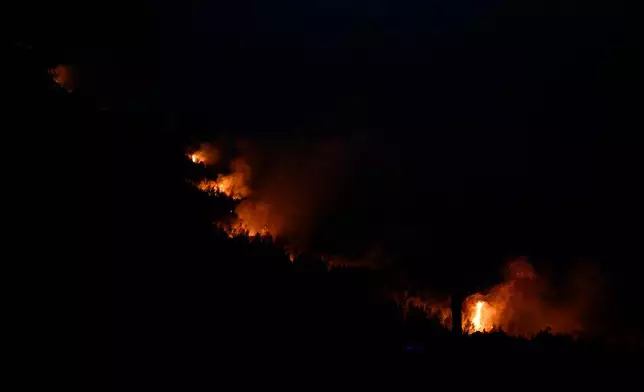 Flames are seen on a mountainside during a wildfire near Porto Germeno, northwest of Athens, Greece, Sunday, Aug. 2, 2026. (AP Photo/Michael Varaklas)