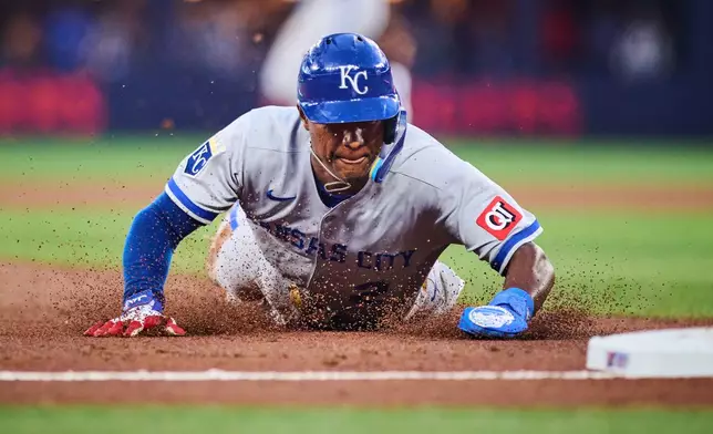 Kansas City Royals' Tyler Tolbert (2) slides in to steal third base during third inning of a baseball game against the Toronto Blue Jays in Toronto, Wednesday, Aug. 26, 2026. (Sammy Kogan/The Canadian Press via AP)