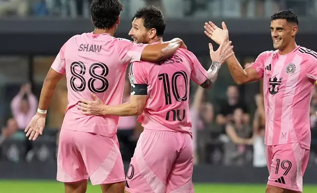 Inter Miami forward Lionel Messi (10) celebrates with forward German Berterame (19), and midfielder Alexander Shaw (88) after scoring his third goal of the match, his side's fifth, during the second half of an MLS soccer match, Saturday, Aug. 29, 2026, in Miami. (AP Photo/Rebecca Blackwell)