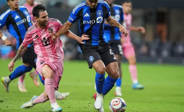 Inter Miami forward Lionel Messi, left, battles with CF Montreal defender Brayan Vera (4) during the second half of an MLS soccer match, Saturday, Aug. 29, 2026, in Miami. (AP Photo/Rebecca Blackwell)