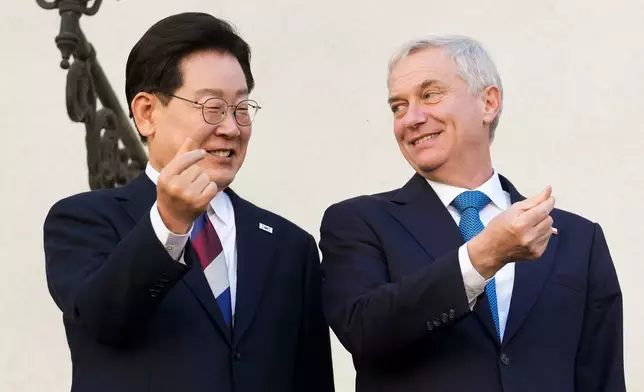 South Korea's President Lee Jae-myung, left, and Chile's President Jose Antonio Kast gesture to the press at La Moneda palace in Santiago, Chile, Thursday, July, 30, 2026. (AP Photo/Esteban Felix)