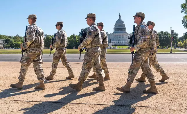 FILE - Armed National Guard soldiers from West Virginia patrol the Mall near the Capitol in Washington, as part of President Donald Trump's order to impose federal law enforcement in the nation's capital, Aug. 26, 2025. (AP Photo/J. Scott Applewhite, File)