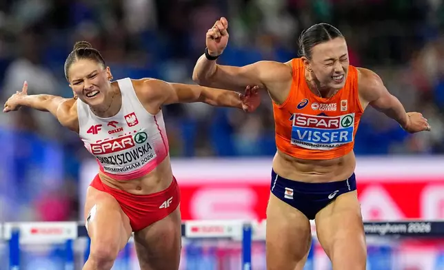 Netherlands' Nadine Visser crosses the line to win gold ahead of Poland's Pia Skrzyszowska, silver, in the women's 100 meters hurdles final at the European Athletics Championships in Birmingham, England, Tuesday, Aug. 11, 2026. (AP Photo/Petr David Josek)