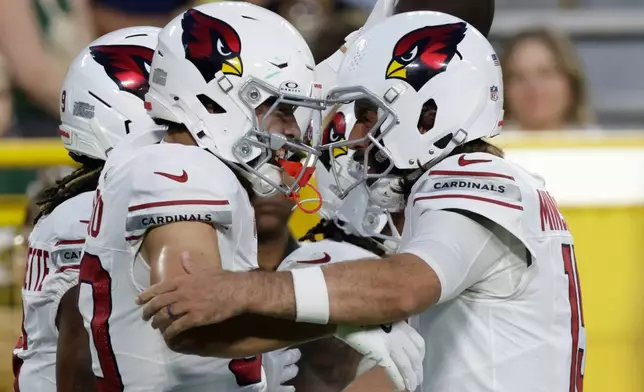 Arizona Cardinals' Simi Fehoko celebrates his touchdown catch with Gardner Minshew II during the first half of a preseason NFL football game against the Green Bay Packers Friday, Aug. 28, 2026, in Green Bay, Wis. (AP Photo/Matt Ludtke)