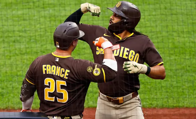 San Diego Padres' Fernando Tatis Jr. celebrates with Ty France (25) after hitting a home run against the New York Mets during the first inning of a baseball game, Tuesday, Aug. 18, 2026, in New York. (AP Photo/Noah K. Murray)