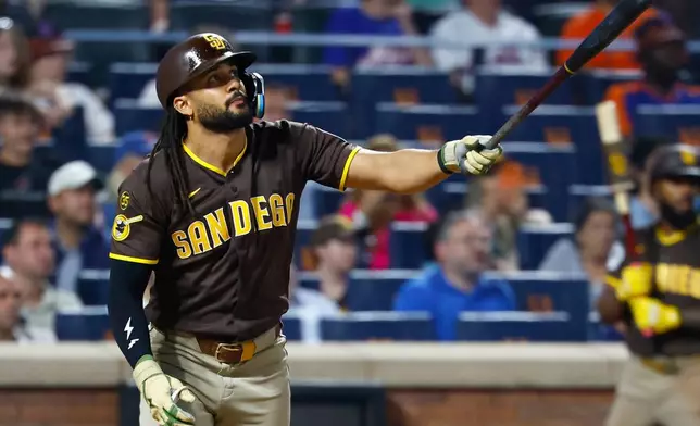 San Diego Padres' Fernando Tatis Jr. follows through on a two run home run against the New York Mets during the fifth inning of a baseball game, Tuesday, Aug. 18, 2026, in New York. (AP Photo/Noah K. Murray)
