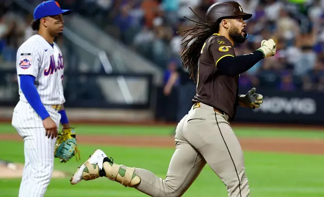 San Diego Padres' Fernando Tatis Jr. reacts after hitting a two run home run against the New York Mets during the fifth inning of a baseball game, Tuesday, Aug. 18, 2026, in New York. (AP Photo/Noah K. Murray)