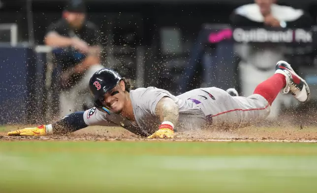 Boston Red Sox's Jarren Duran scores on a double hit by Mickey Gasper during the fifth inning of a baseball game against the Miami Marlins, Monday, Aug. 24, 2026, in Miami. (AP Photo/Lynne Sladky)