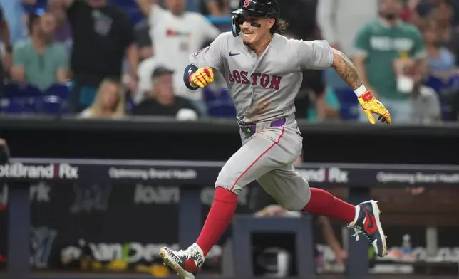 Boston Red Sox's Jarren Duran runs to score on a double hit by Mickey Gasper during the fifth inning of a baseball game against the Miami Marlins, Monday, Aug. 24, 2026, in Miami. (AP Photo/Lynne Sladky)
