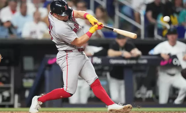 Boston Red Sox's Caleb Durbin hits a single during the fifth inning of a baseball game against the Miami Marlins, Monday, Aug. 24, 2026, in Miami. (AP Photo/Lynne Sladky)