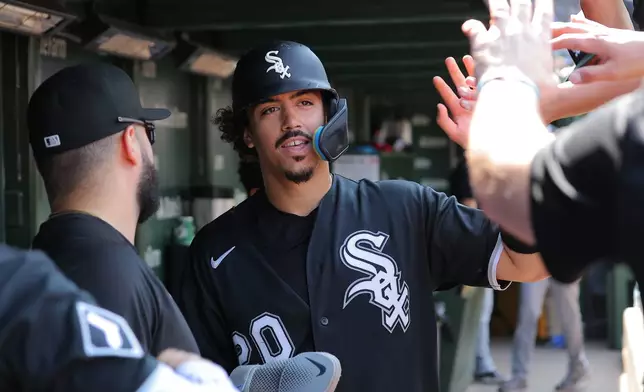 Chicago White Sox's Miguel Vargas celebrates in the dugout after scoring on Braden Montgomery's two-run double during the eighth inning of a baseball game against the Chicago Cubs, Wednesday, Aug. 19, 2026, in Chicago. (AP Photo/Melissa Tamez)