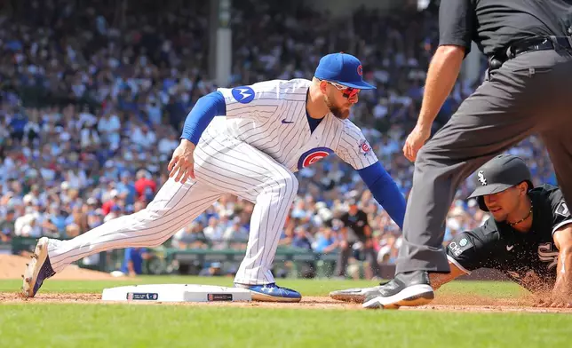 Chicago Cubs' Michael Busch tags out Chicago White Sox's Braden Montgomery at first base on a pick off throw from Caleb Thielba during the sixth inning of a baseball game, Wednesday, Aug. 19, 2026, in Chicago. (AP Photo/Melissa Tamez)